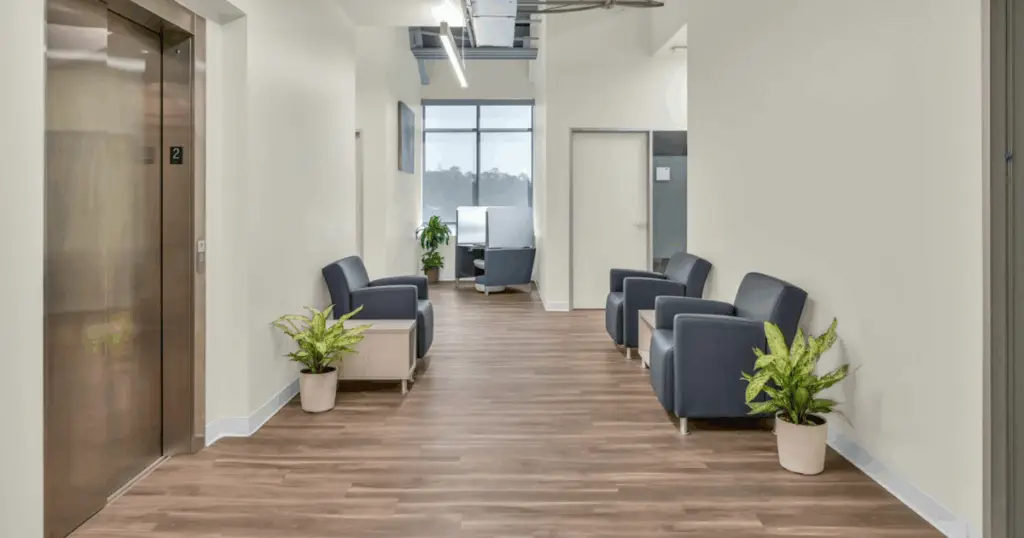 Coworking lounge area with seating and elevator access at Strive Coworking Workspaces in Cypress, Texas