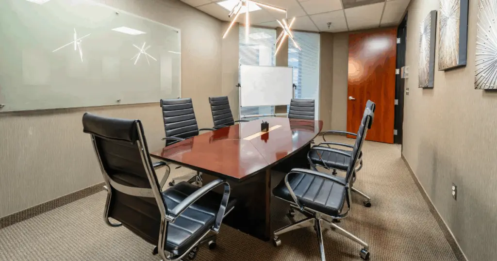Plano meeting space at Strive Workspaces with private conference room, boardroom table, and presentation setup.
