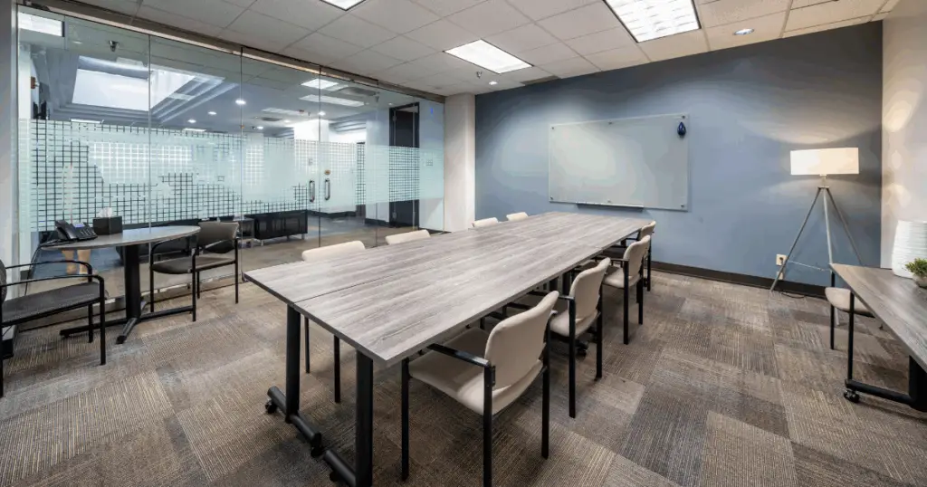 North Dallas meeting room at Strive Workspaces featuring conference seating, AV-ready setup, and glass-enclosed design.
