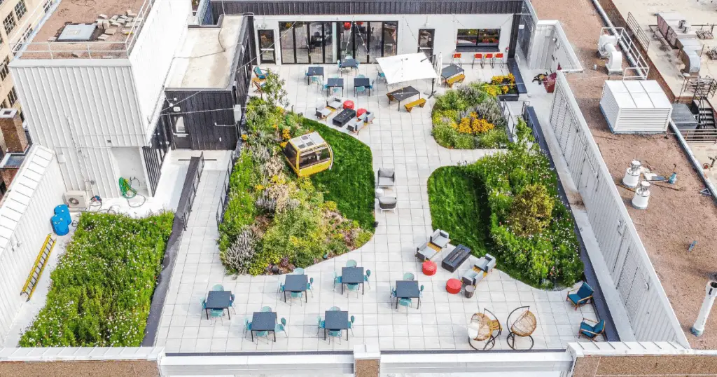 Rooftop event space at Strive Coworking Workspaces with landscaped green areas, outdoor seating, and flexible gathering spaces.