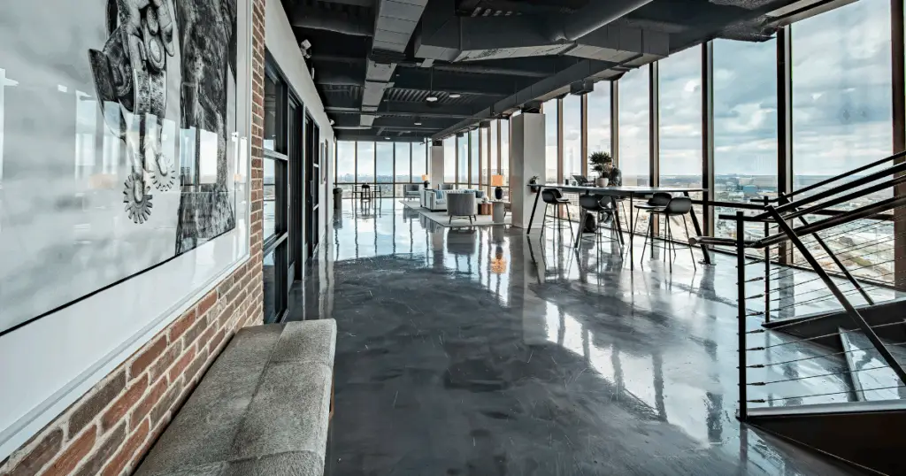 Open coworking lounge with floor-to-ceiling windows and city views at Strive Coworking Workspaces