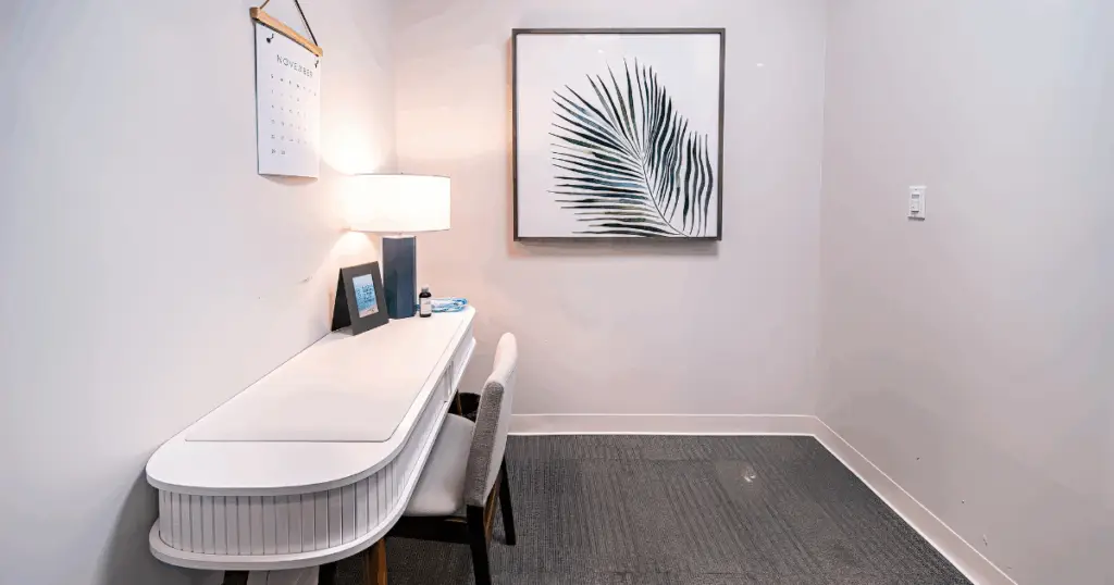 Private phone room at Flex at The Gild in Dallas, Texas, featuring a compact desk, task chair, and sound-controlled workspace.