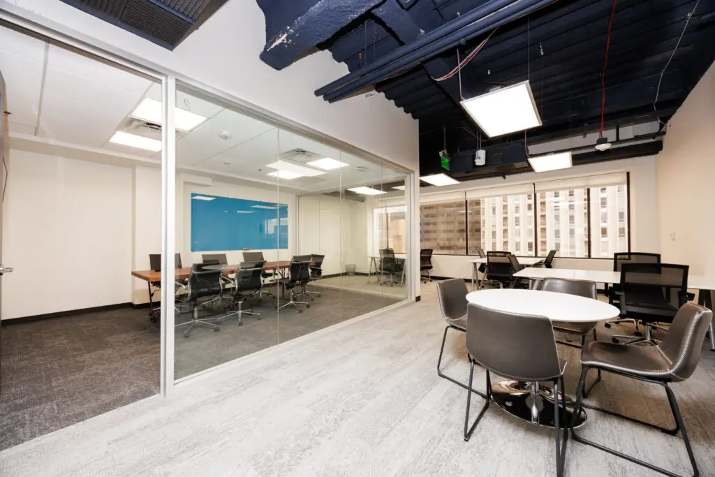 Professional meeting room with modern design, conference table, and presentation screen for client meetings