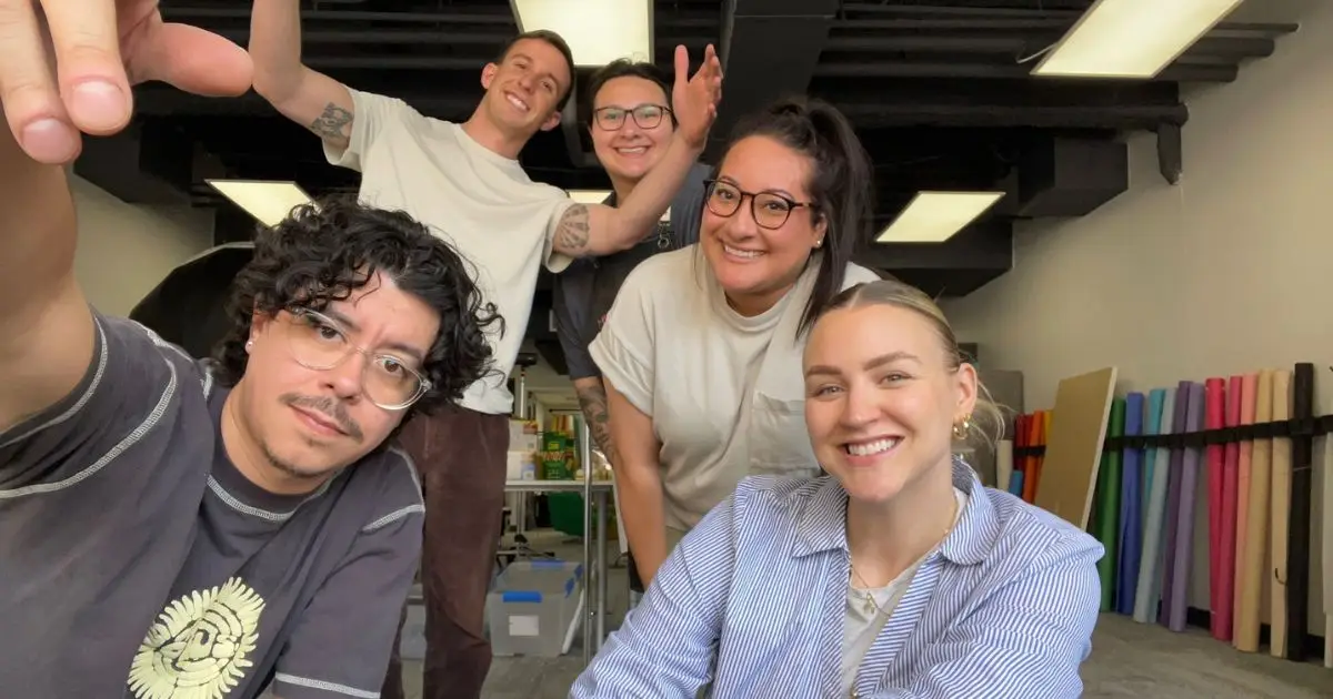 team picture at their office space within a coworking space